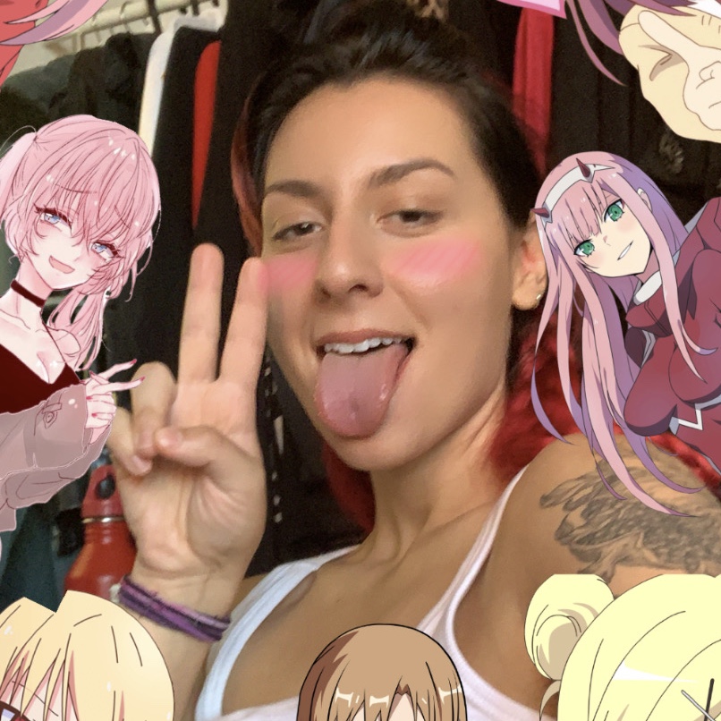 Photo of D with their tongue out, surrounded by anime characters