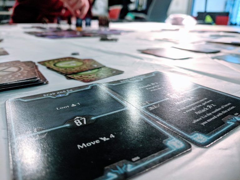 a photograph of a pair of cards from gloomhaven that describe character abilities