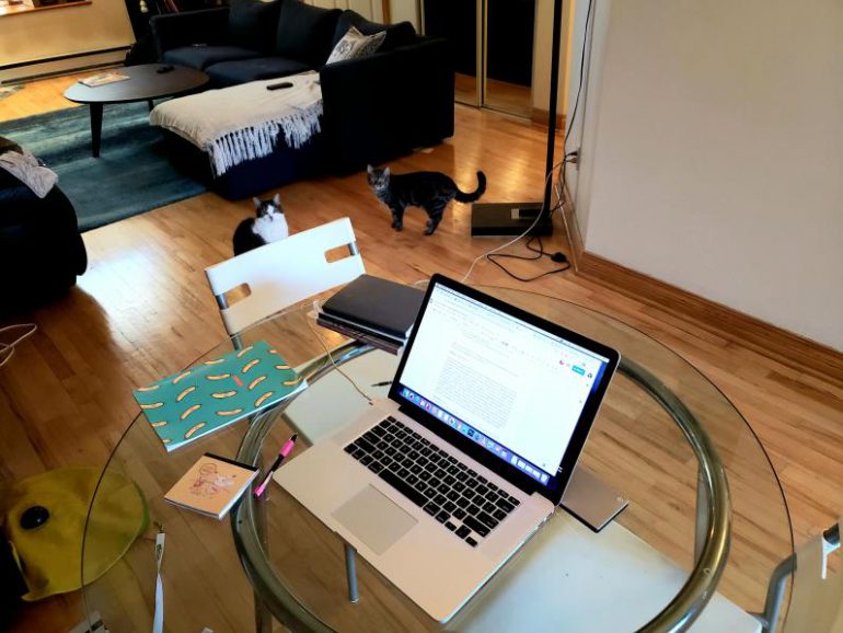 a laptop set up on a class table in a living room