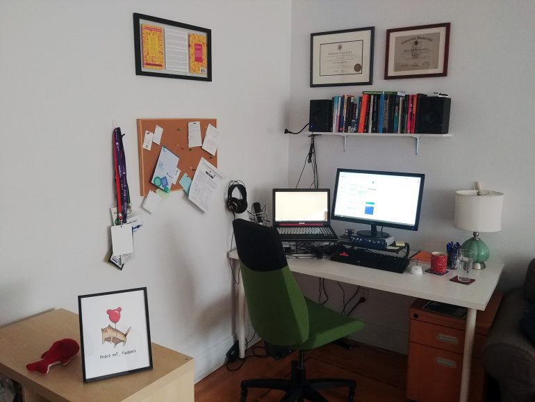 an office set up in the corner of a living room